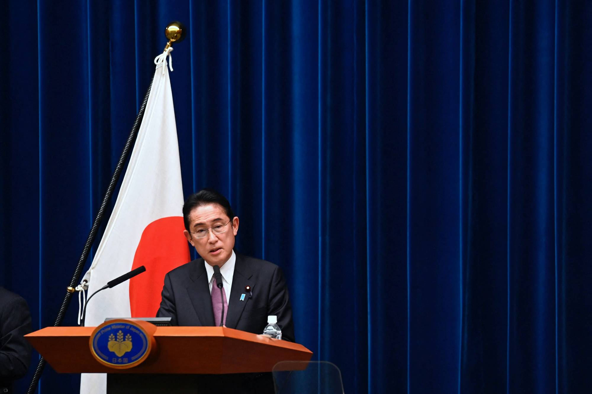Prime Minister Fumio Kishida speaks at a news conference in Tokyo on Friday. | POOL / VIA REUTERS