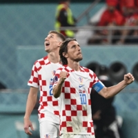 Croatia\'s midfielder Luka Modric (right) celebrates after winning the Qatar 2022 World Cup third-place match against Morocco at Khalifa International Stadium in Doha on Saturday. | AFP-JIJI