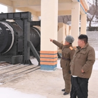 North Korean leader Kim Jong Un attends the test of a new solid-fuel missile engine at the Sohae Satellite Launching Ground in North Korea in this photo released Friday. |  KCNA / KNS / VIA AFP-JIJI
