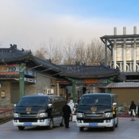 Workers move a casket outside a crematorium at a funeral home in Beijing on Saturday. | REUTERS
