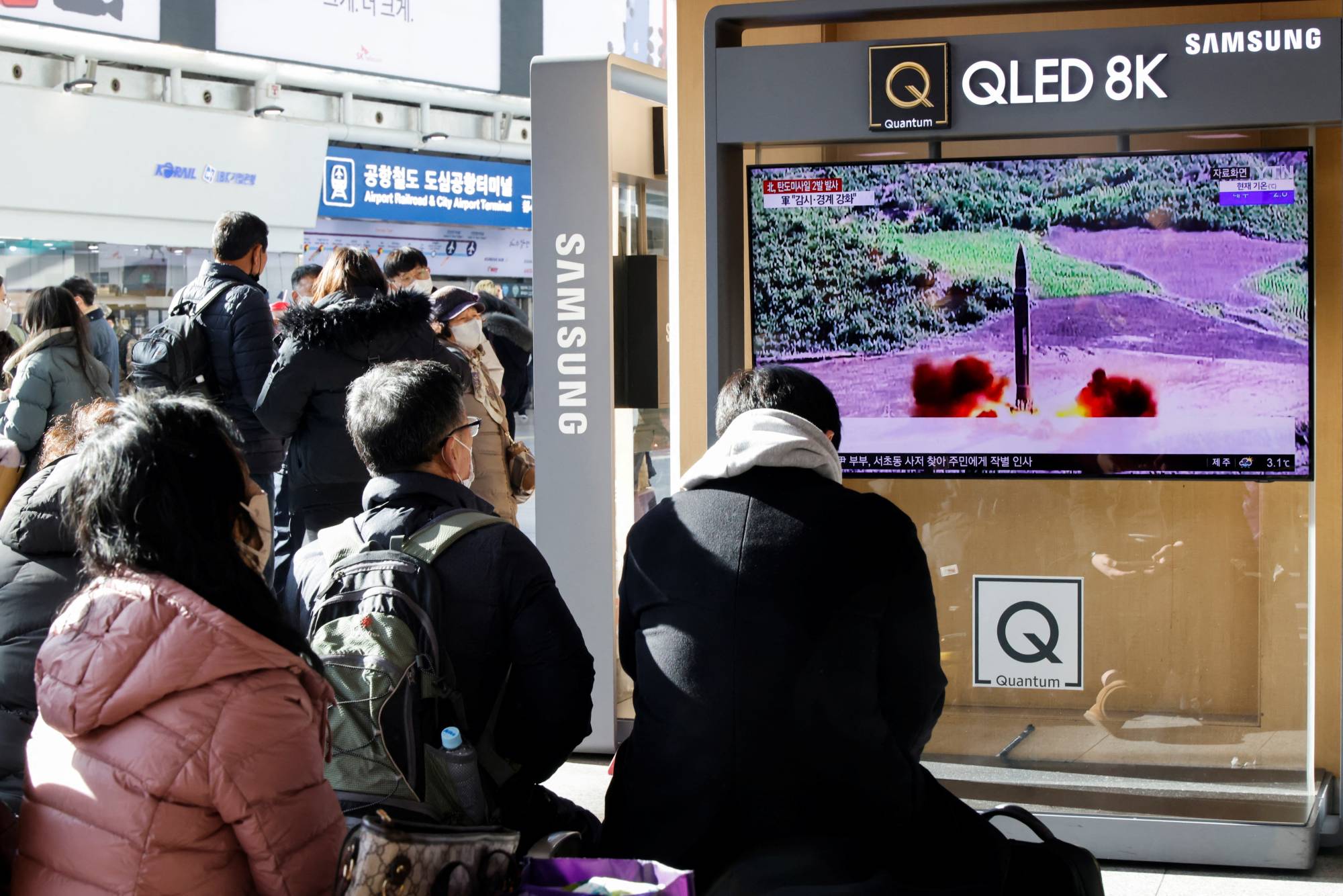 People watch a TV news report on North Korea's ballistic missile launches, in Seoul on Sunday. | REUTERS