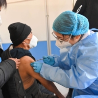A man receives a COVID-19 vaccine in Qingzhou, in China\'s eastern Shandong province, on Friday. | AFP-JIJI