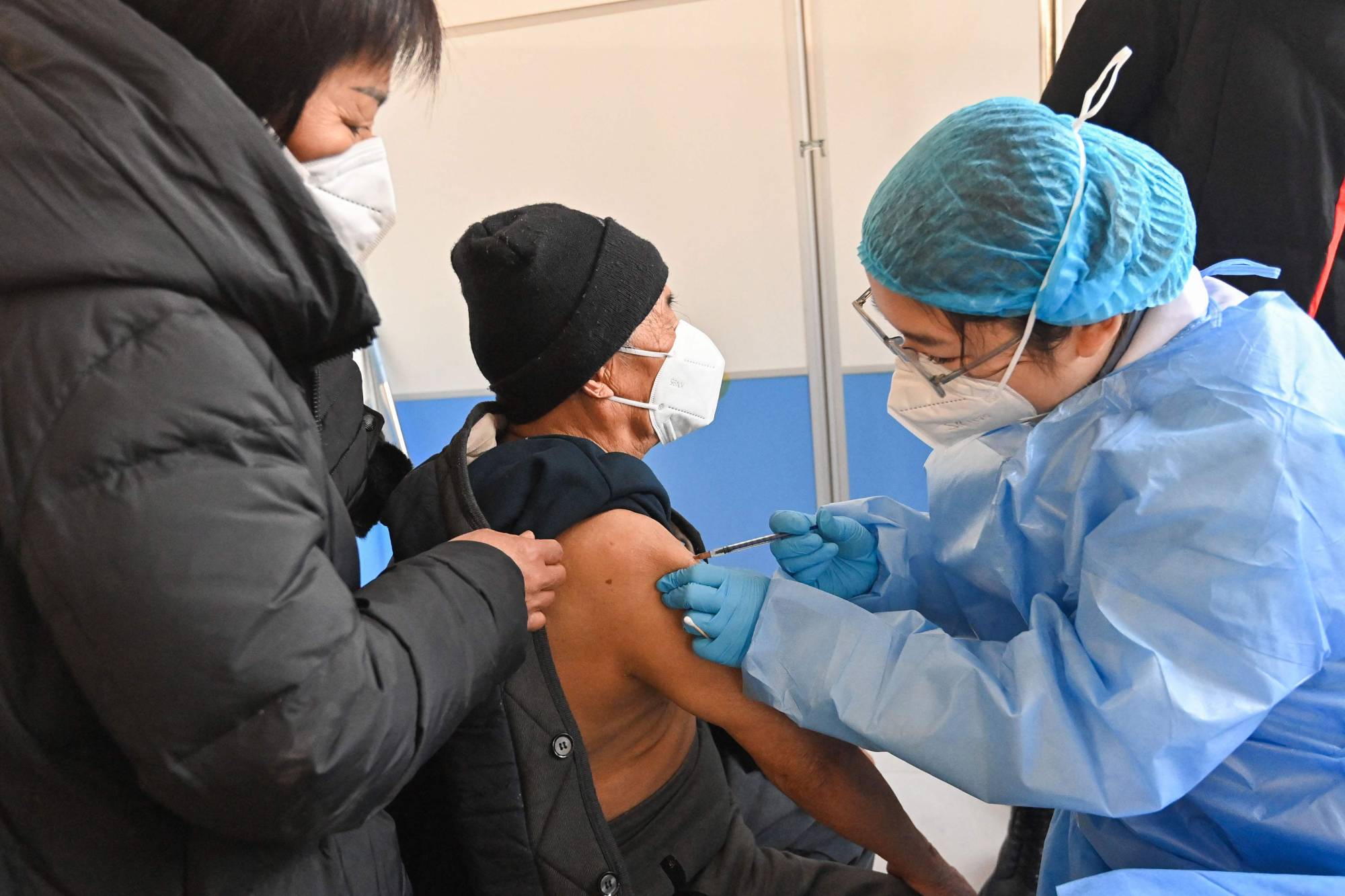 A man receives a COVID-19 vaccine in Qingzhou, in China's eastern Shandong province, on Friday. | AFP-JIJI