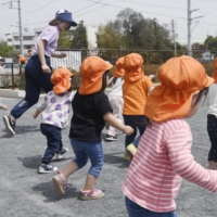 The government is considering increasing the subsidy for nurseries that place more teachers than required. | KYODO