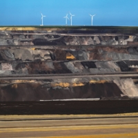 Wind turbines stand above an open-cast lignite mine in Germany. | INA FASSBENDER / AFP / VIA GETTY IMAGES