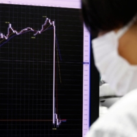 The sudden move of the yen against the U.S. dollar is displayed on a monitor on Tuesday.  | REUTERS