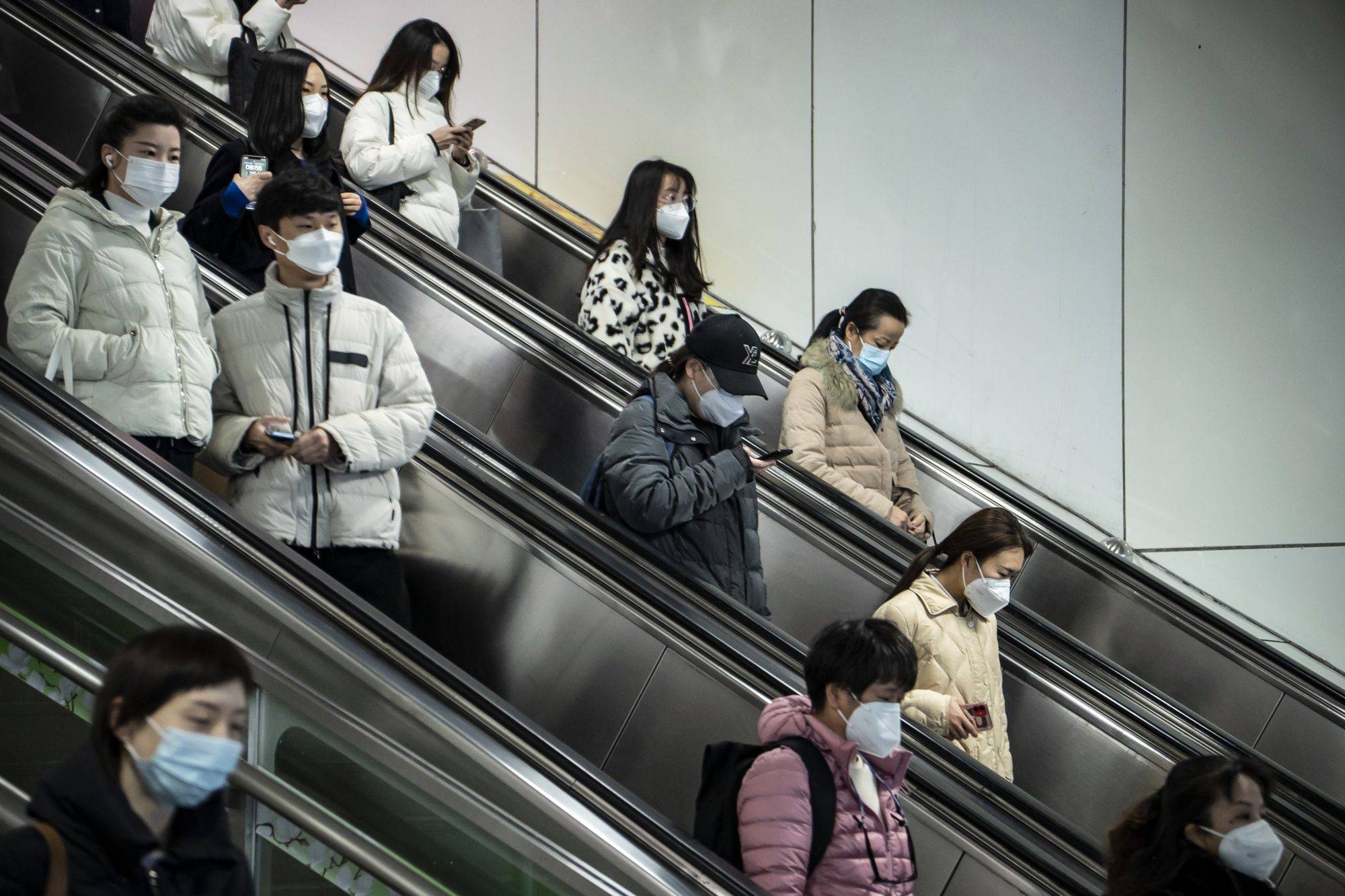Commuters in Shanghai on Tuesday. China appears to be seeing an increase in COVID-19 deaths across a swath of the country that aren't being reported in government figures. | Bloomberg