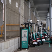 Luup e-scooters at a pickup point in Tokyo\'s Meguro Ward on Dec. 17. The Tokyo-based startup now enjoys more than a 90% market share for e-scooter rentals, boasting a fleet of approximately 5,000 e-scooters and e-bikes across roughly 2,340 pickup points throughout the country. | CHRIS RUSSELL
