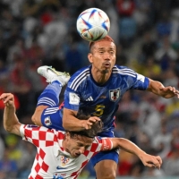 Yuto Nagatomo (top) is the first Japanese player to appear in the field in four World Cups. | AFP-JIJI