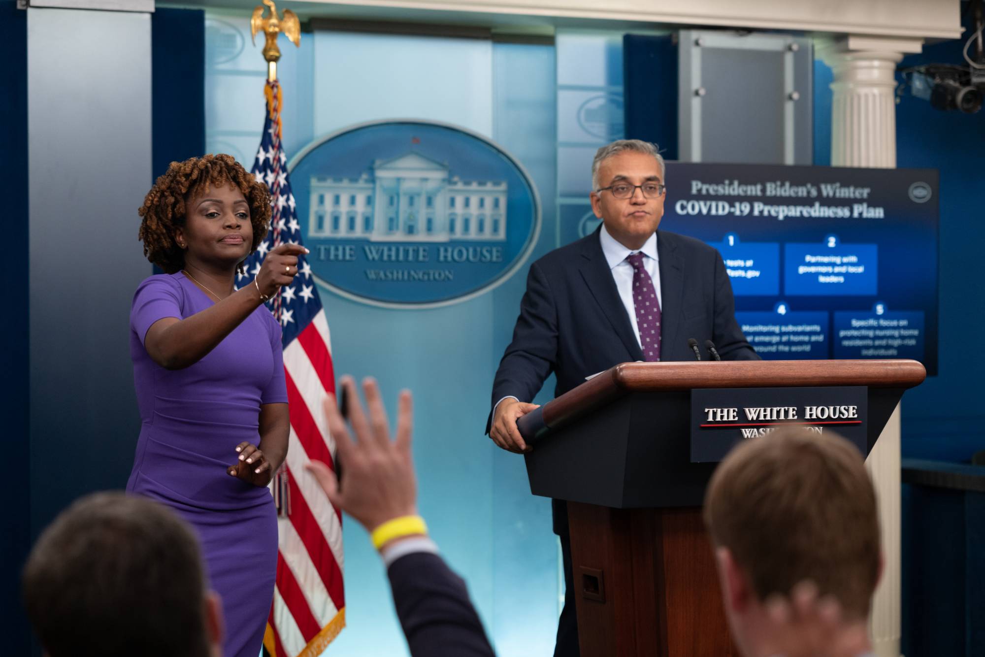 U.S. Press Secretary Karine Jean-Pierre calls on reporters as Dr. Ashish Jha, the pandemic response coordinator for the administration of Joe Biden, speaks at the White House in Washington on Dec. 15. | Cheriss May / The New York Times