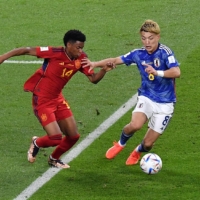 Japan\'s Ritsu Doan (right) and Spain\'s Alejandro Balde vie for the ball during their Group E match at the World Cup in Doha on Dec. 1. | REUTERS