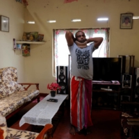 Priyantha Kumarasinghe, 32, who has been diagnosed with lung cancer, which doctors think has spread to his neck and spine, at his aunt\'s house in Homagama in November.  | REUTERS