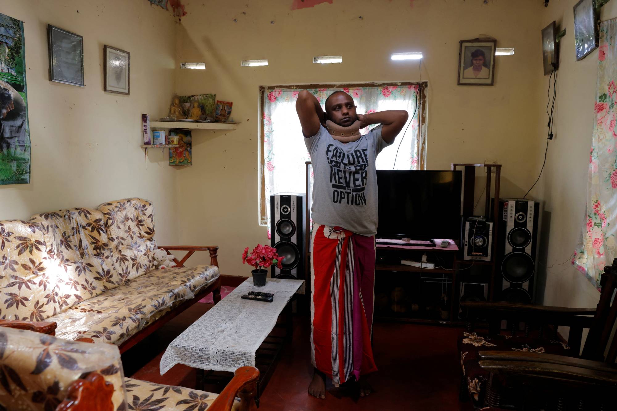 Priyantha Kumarasinghe, 32, who has been diagnosed with lung cancer, which doctors think has spread to his neck and spine, at his aunt's house in Homagama in November. | Reuters