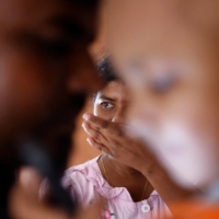 Sathiyaraj Silaksana, 27, cries as her husband Kesakarasa Sathiyaraj, 34, hugs their son, S. Saksan, 5, who has been diagnosed with leukemia.  | REUTERS