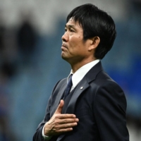 Japan head coach Hajime Moriyasu greets supporters after the team\'s 2022 FIFA World Cup round-of-16 defeat to Croatia in Al-Wakrah, Qatar, on Dec. 5. | AFP-JIJI