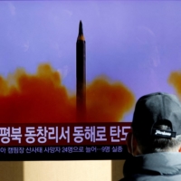 A TV broadcasts a news report on North Korea firing a ballistic missile off its east coast, in Seoul on Dec. 18. | REUTERS