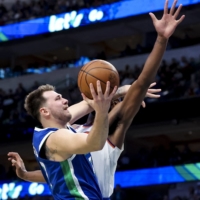 Mavericks guard Luka Doncic attempts a shot while the Knicks\' Mitchell Robinson defends during the second half in Dallas on Tuesday. | USA TODAY / VIA REUTERS