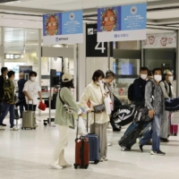 People wearing face masks at New Chitose Airport in Hokkaido in October 2020 | KYODO
