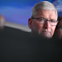 Apple CEO Tim Cook listens to a speech by U.S. President Joe Biden in Phoenix on Dec. 6.  | AFP-JIJI