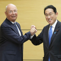 Prime Minister Fumio Kishida poses with Klaus Schwab, founder and executive chairman of the World Economic Forum, in Tokyo on April 25, 2022. | KYODO