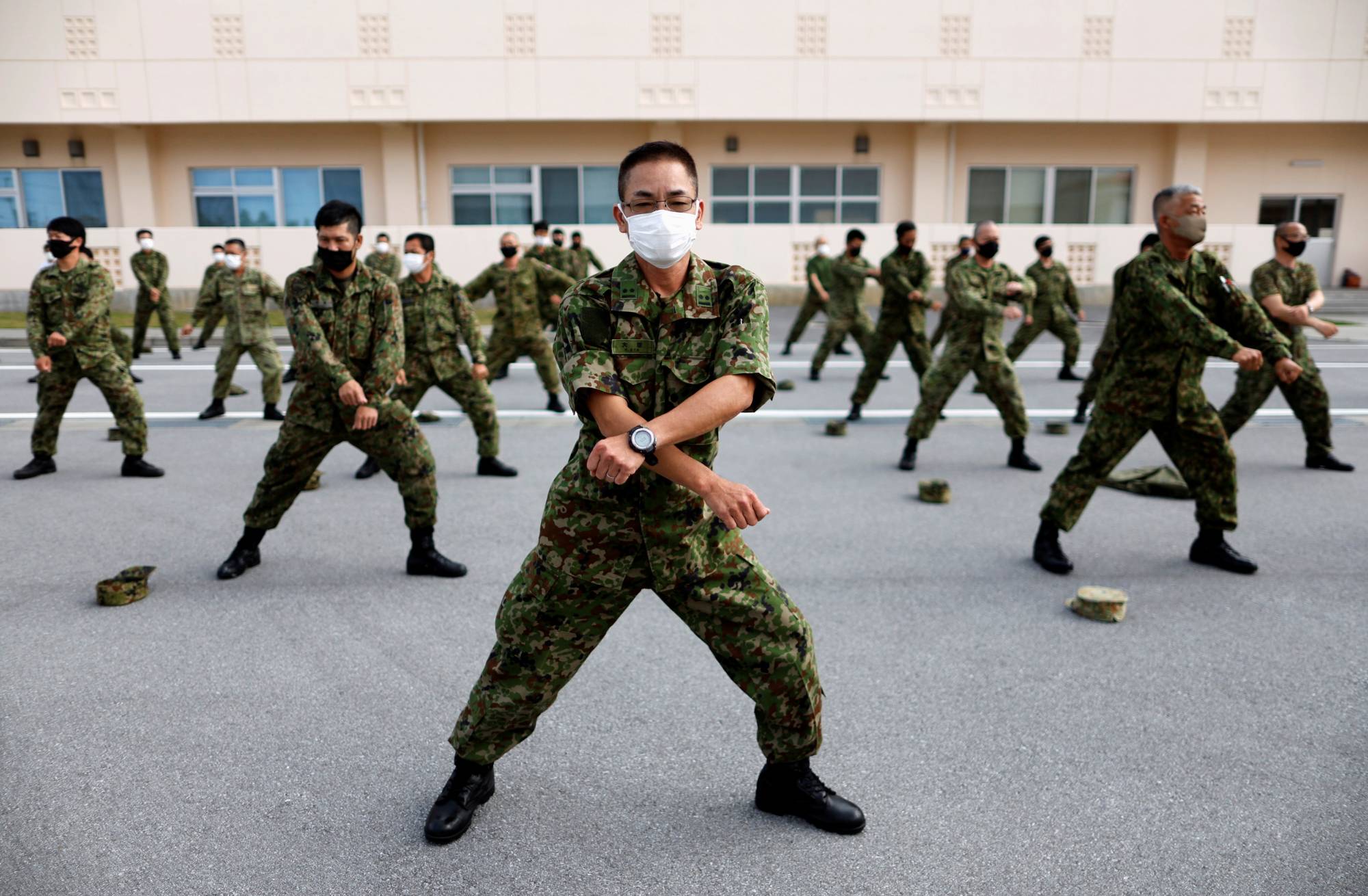 Ground Self-Defense Force members hold morning preparatory exercises at their camp on Miyako Island in Okinawa Prefecture in April. | REUTERS