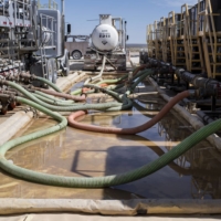Water is pumped into machinery at a hydraulic fracking site near Mentone, Texas, in March 2017. | BLOOMBERG
