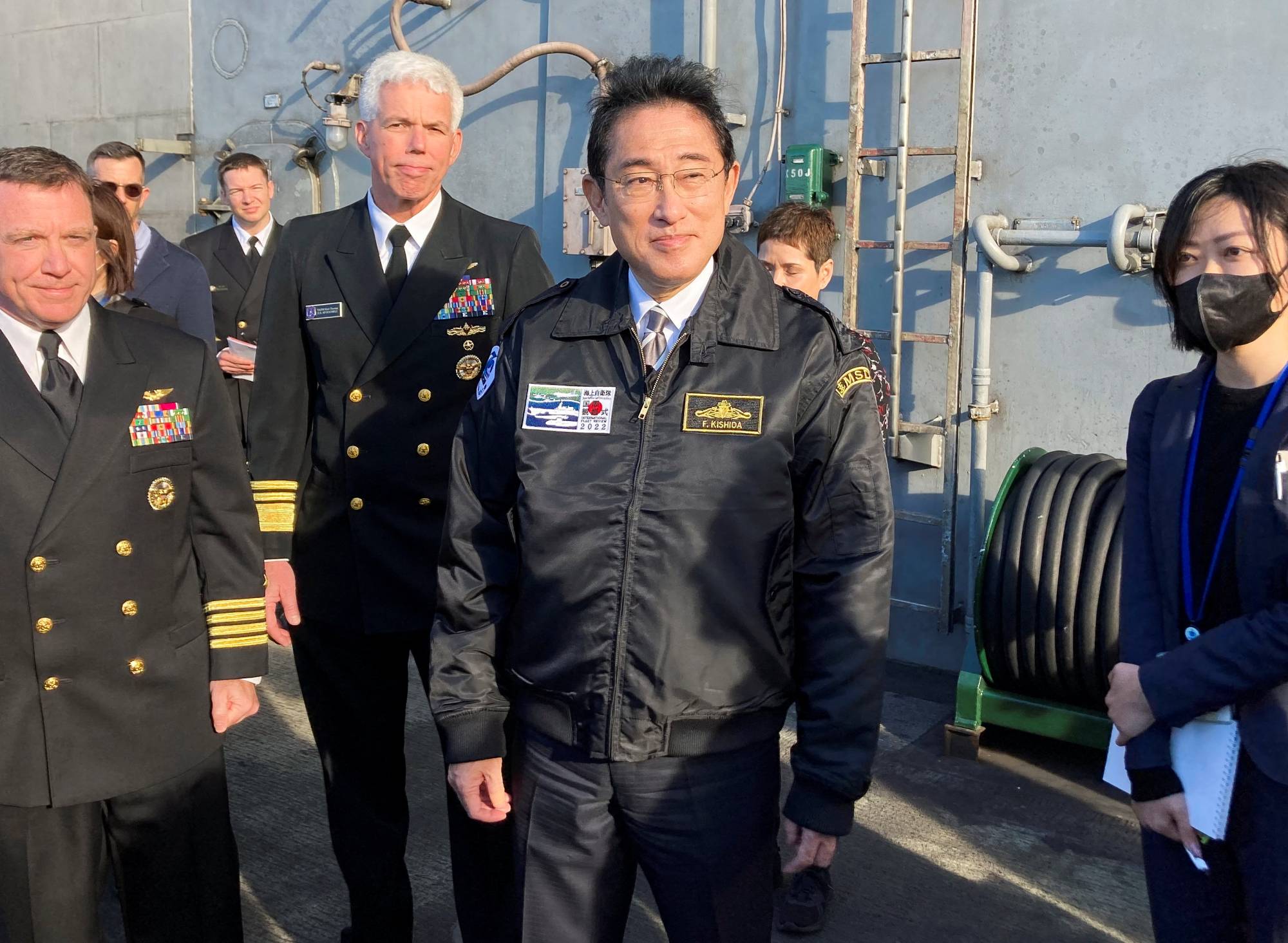 Prime Minister Fumio Kishida boards the USS Ronald Reagan supercarrier at Sagami Bay, off Kanagawa Prefecture, on Nov. 6. To deter countries from challenging the international order, Japan must coordinate with the United States and other governments around the world to share information. | REUTERS