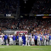 Bills players surround safety Damar Hamlin as he\'s treated after collapsing during an NFL game against the Bengals in Cincinnati on Monday. | USA TODAY / VIA REUTERS
