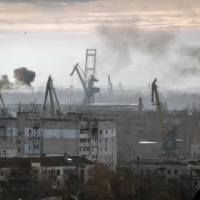 Smoke rises during a Russian attack on the port of Kherson, on Ukraine\'s Black Sea coast. Before the war, farmers shipped out 95% of the country\'s wheat and grain exports through the Black Sea.  | FINBARR OﾕREILLY / THE NEW YORK TIMES
