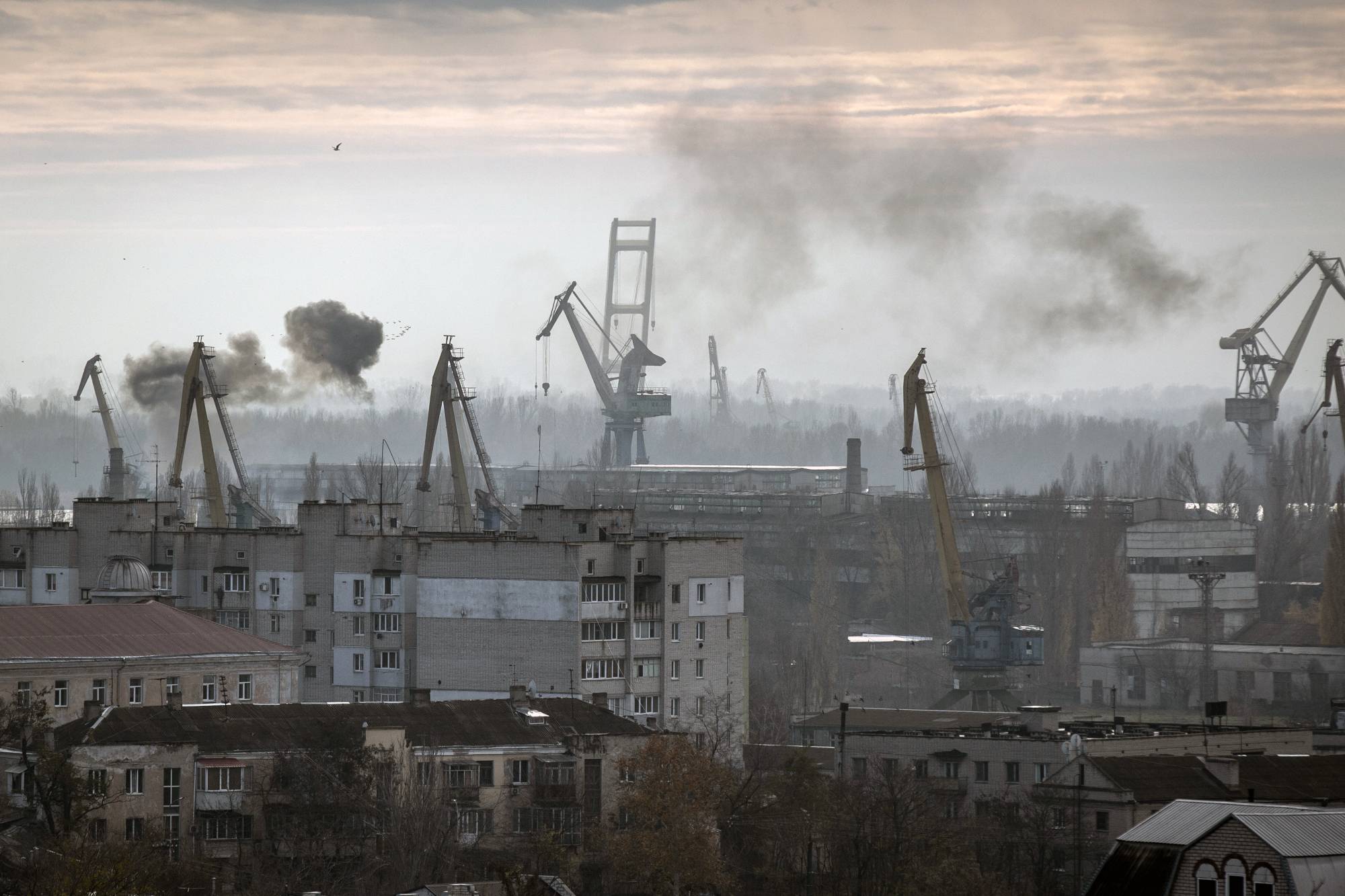 Smoke rises during a Russian attack on the port of Kherson, on Ukraine's Black Sea coast. Before the war, farmers shipped out 95% of the country's wheat and grain exports through the Black Sea. | Finbarr OﾕReilly / The New York Times