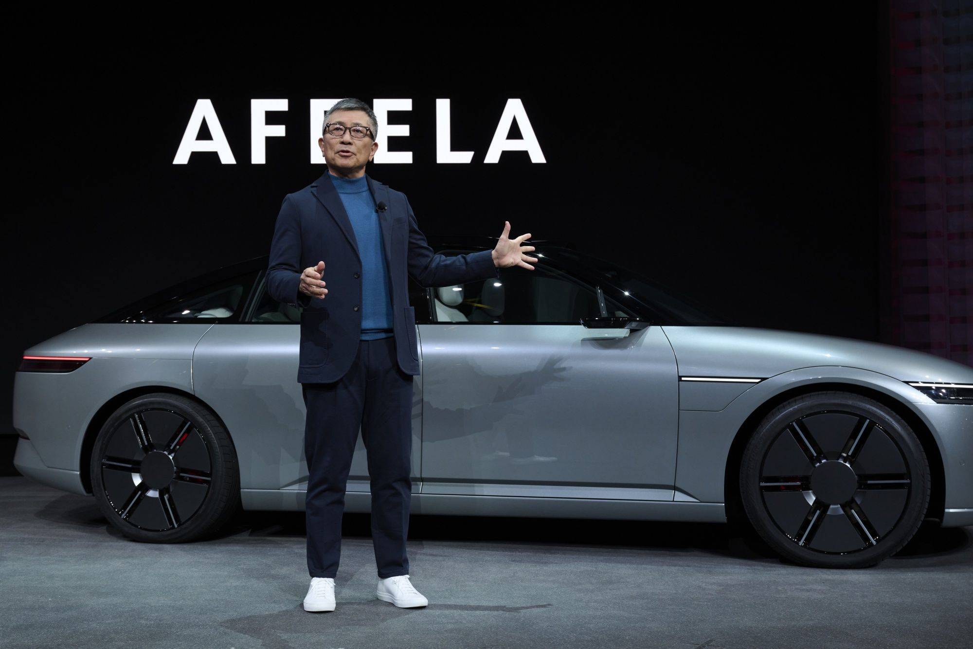 Yasuhide Mizuno, chairman and chief executive officer of Sony Honda Mobility, speaks in front of an Afeela prototype car during a press event at the 2023 Consumer Electronics Show in Las Vegas on Thursday. | BLOOMBERG