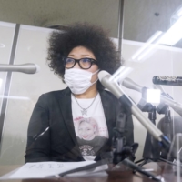 Kyoko Kimura speaks at a news conference in Tokyo in May 2021 after the Tokyo District Court awarded her ¥1.29 million in damages over hateful messages posted about her daughter.  | KYODO