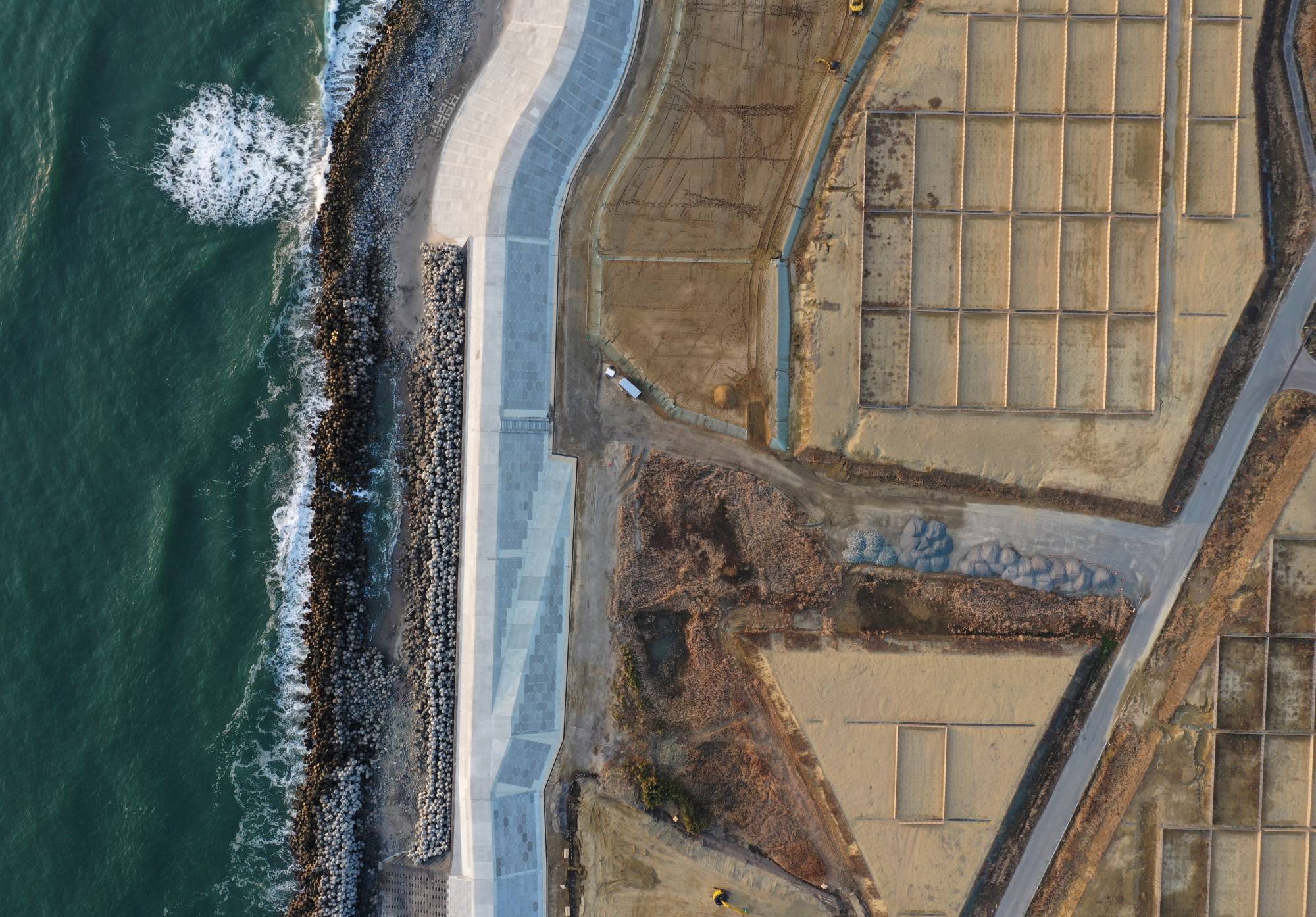 A seawall under construction in Namie, Fukushima Prefecture, in February 2021 | REUTERS