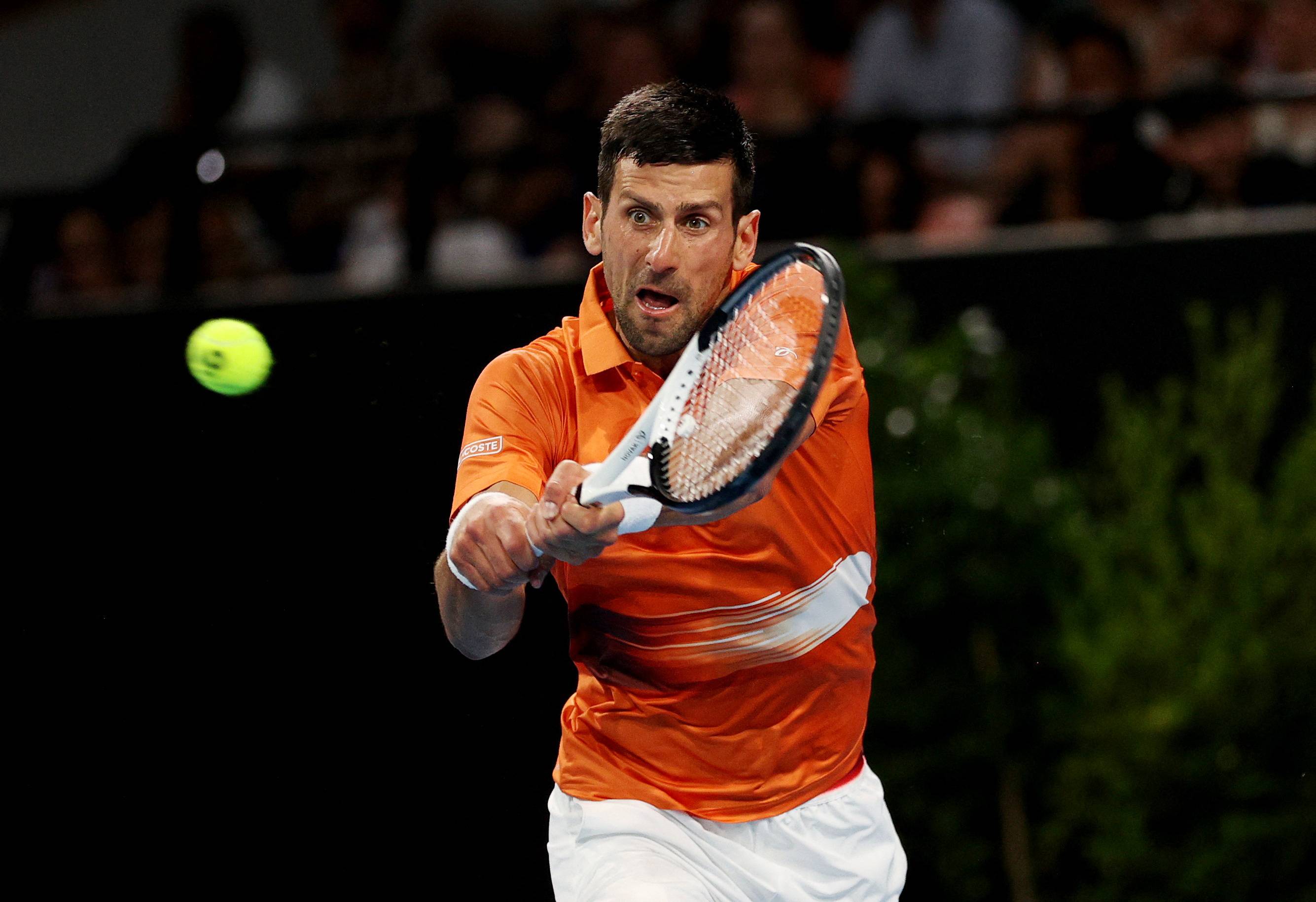 Novak Djokovic returns a ball to Daniil Medvedev during their Adelaide International 1 semifinal in Adelaide, Australia, on Saturday. | REUTERS