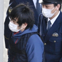 Tetsuya Yamagami, who is suspected of killing former Prime Minister Shinzo Abe, enters a Nara police station after being detained for a psychiatric evaluation on Tuesday. | KYODO