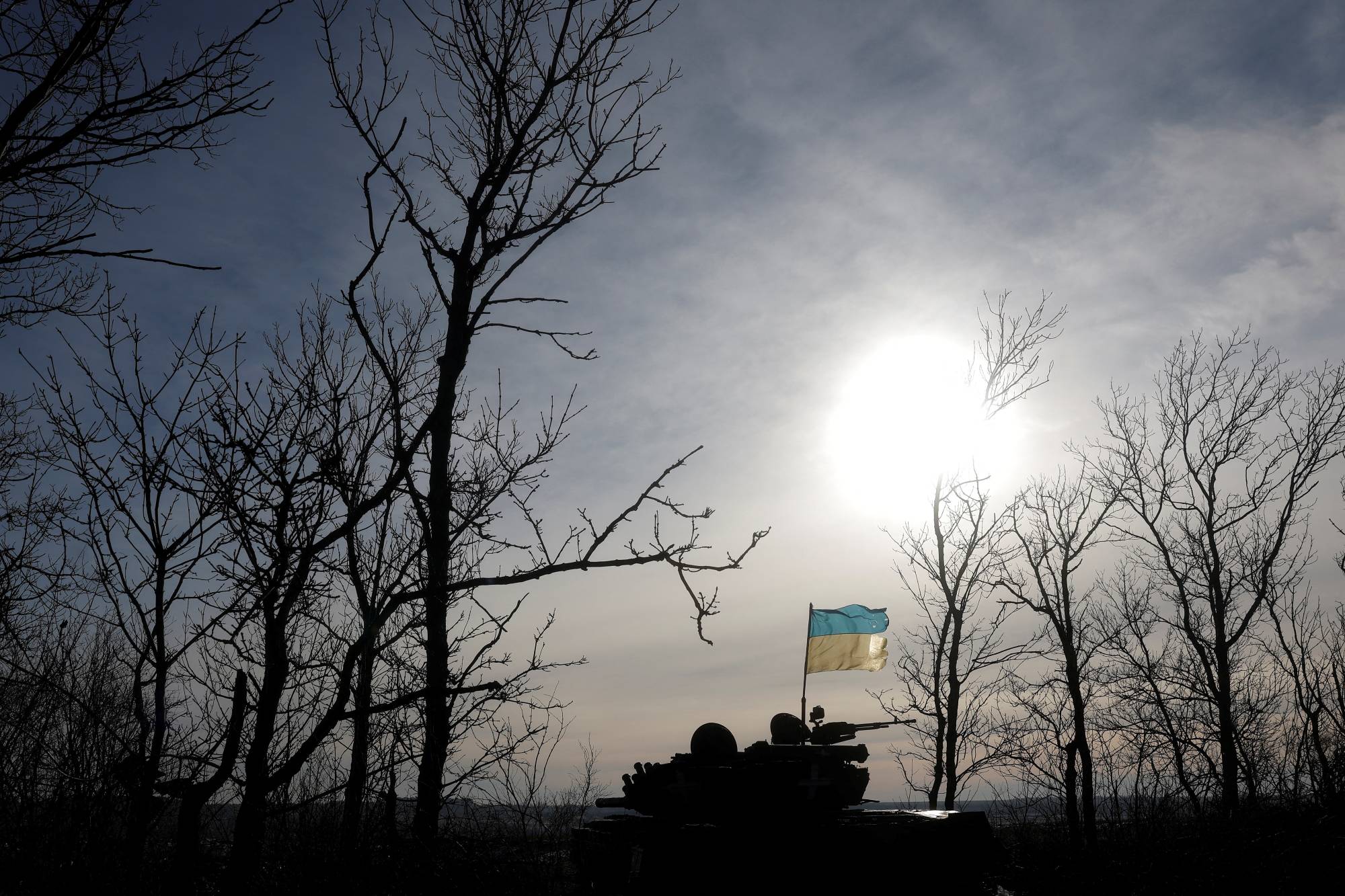 A Ukrainian flag affixed to a tank flutters in the wind in Bakhmut, Ukraine, on Tuesday. | Reuters