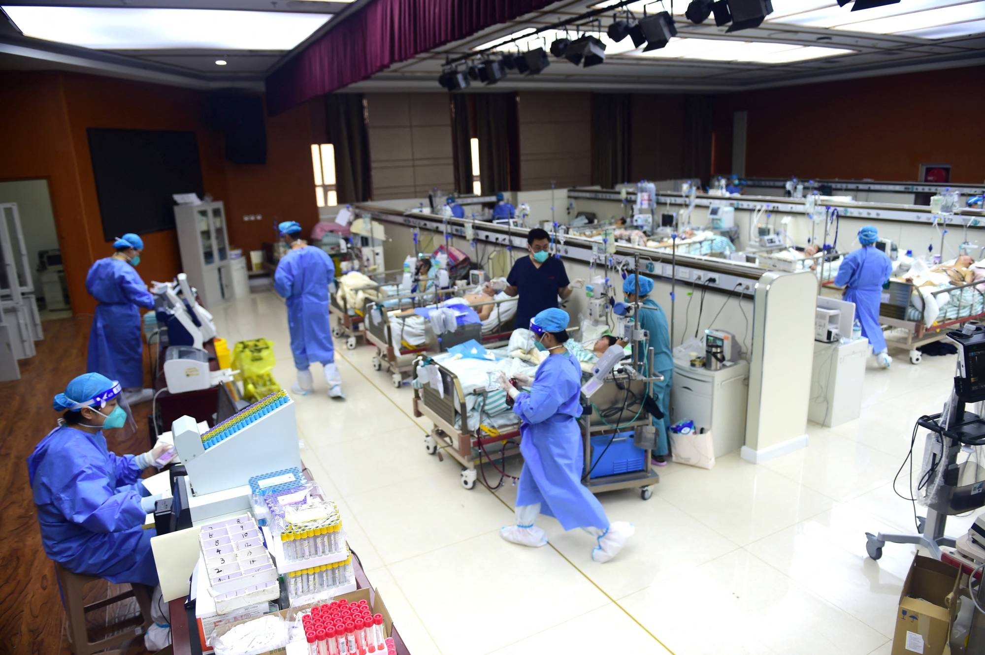 Medical workers attend to COVID-19 patients at an intensive care unit set up in a conference room at a hospital in Cangzhou, China, on Wednesday. | CHINA DAILY / VIA REUTERS