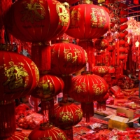 A vendor looks on at Chinese lanterns at a shop in Ruili, China, on Friday. | AFP-JIJI