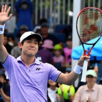 Japan\'s Yoshihito Nishioka celebrates victory against Sweden\'s Mikael Ymer during their men\'s singles match on Day 1 of the Australian Open in Melbourne on Monday. | AFP-JIJI