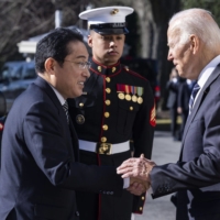 U.S President Joe Biden greets Prime Minister Fumio Kishida at the White House in Washington on Friday.  | BLOOMBERG
