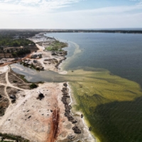 Boats lie on the bank of Senegal\'s Pink Lake (Lac Rose), officially known as Lake Retba, after extreme floods washed away salt mounts and contaminated the lake, turning its famous waters from pink to green. | REUTERS