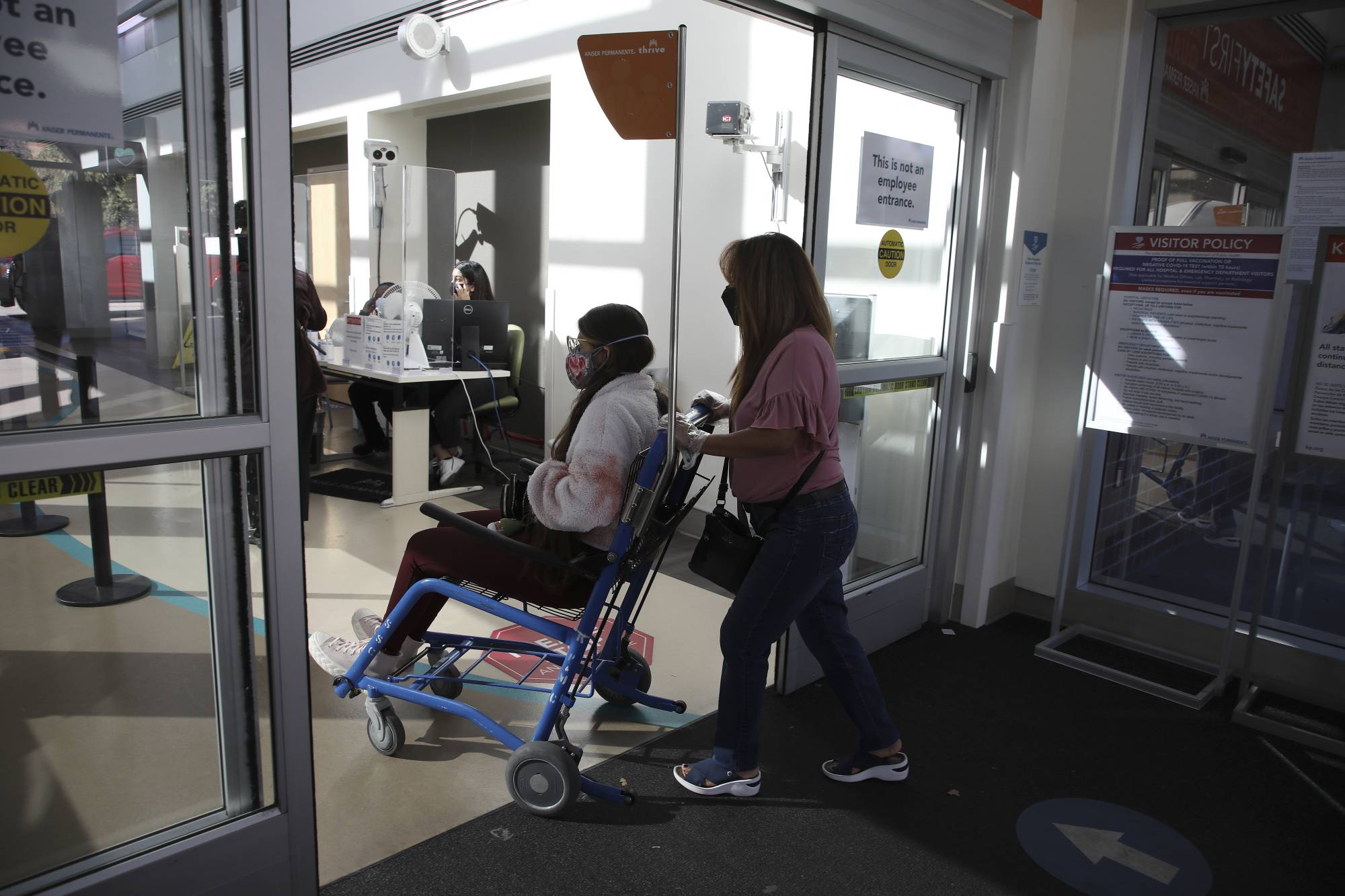 A long COVID-19 patient is brought by her mother into a hospital in Sacramento, California in October 2021.  | JIM WILSON / THE NEW YORK TIMES