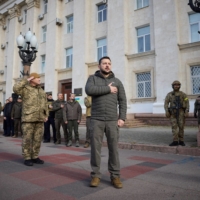 Ukrainian President Volodymyr Zelenskyy visits the city of Kherson soon after it was liberated in mid-November from Russian forces.  | UKRAINIAN PRESIDENTIAL PRESS SERVICE / VIA REUTERS 