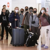 Travelers from abroad arrive at Tokyo\'s Haneda Airport in October. | KYODO