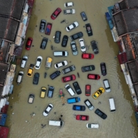 Vehicles and buildings inundated by floods in Shah Alam in Malaysia\'s Selangor state on Dec. 21, 2021 | REUTERS