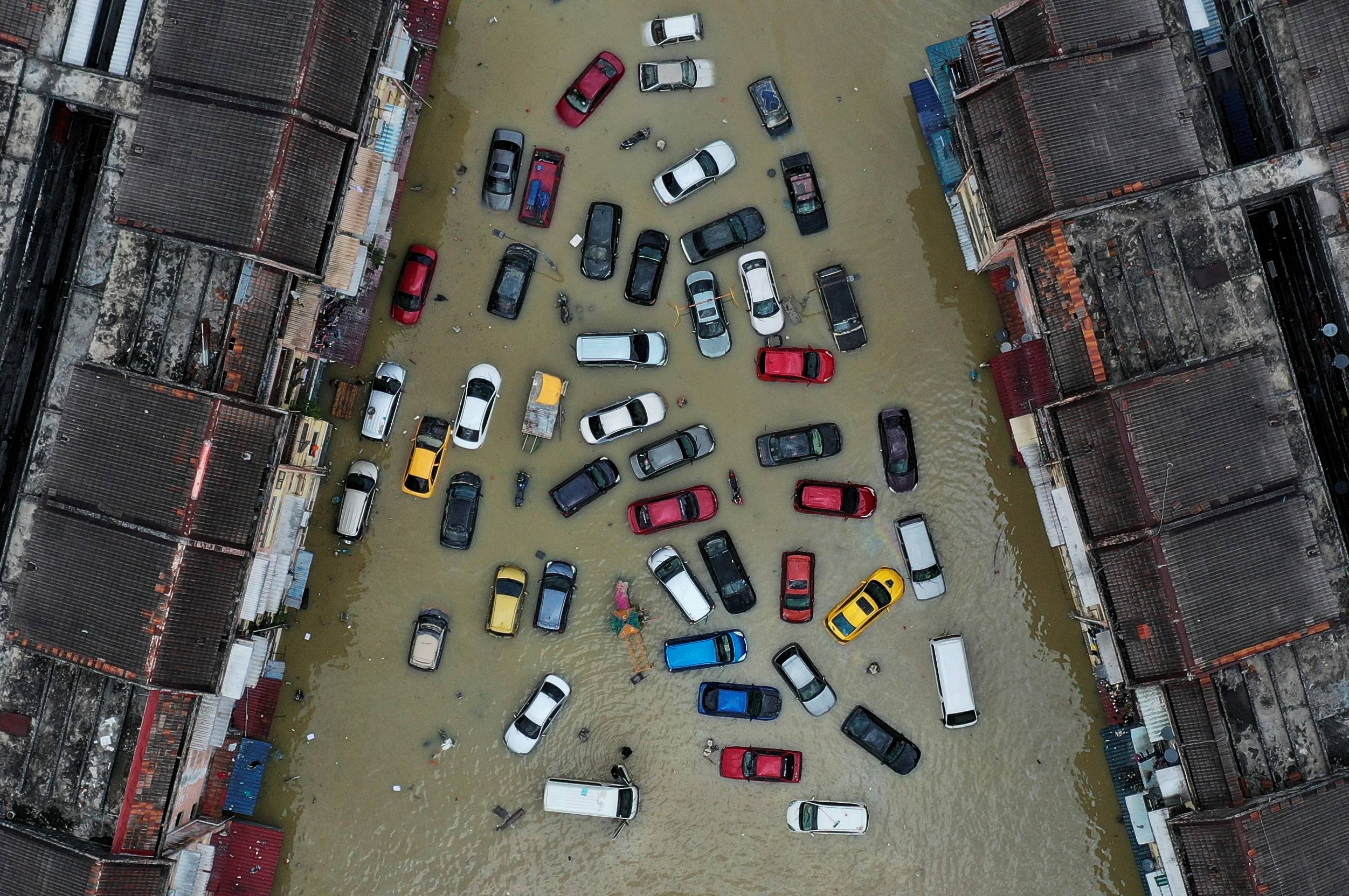 Vehicles and buildings inundated by floods in Shah Alam in Malaysia's Selangor state on Dec. 21, 2021 | Reuters