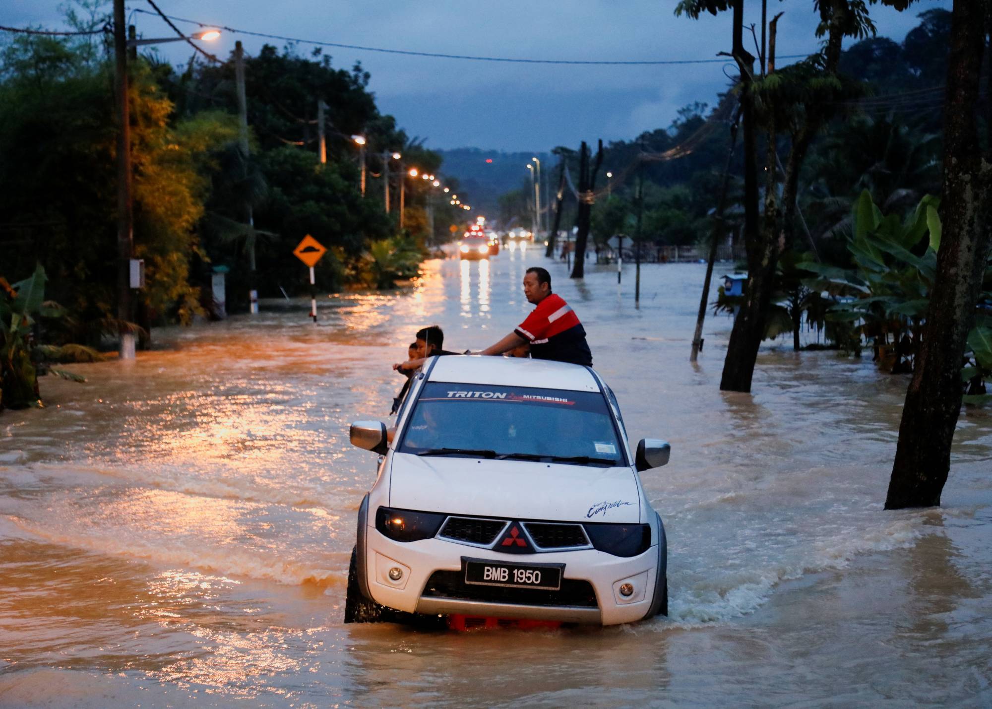 A pickup truck wades through a flooded area following heavy rainfall in Klang in Malaysia's Selangor state on Nov. 10 last year. | Reuters