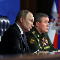 Russian President Vladimir Putin and Gen. Valery Gerasimov attend a meeting in Moscow on Dec. 21.  | AFP-JIJI
