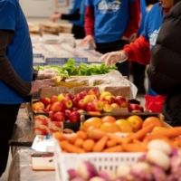 Volunteers organize donated food aid for students at a distribution point in Paris on Thursday. | BLOOMBERG