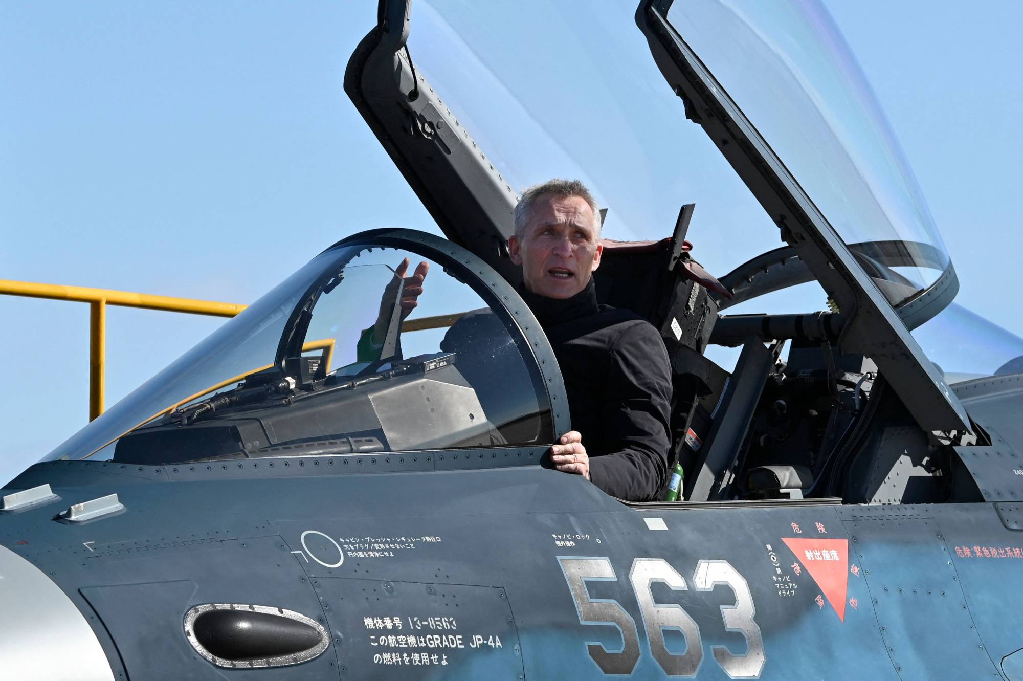 NATO Secretary-General Jens Stoltenberg gets into the cockpit of an Air Self-Defense Force F-2 fighter jet during an inspection at the Iruma Air Base in Sayama, Saitama Prefecture, on Tuesday. | AFP-JIJI